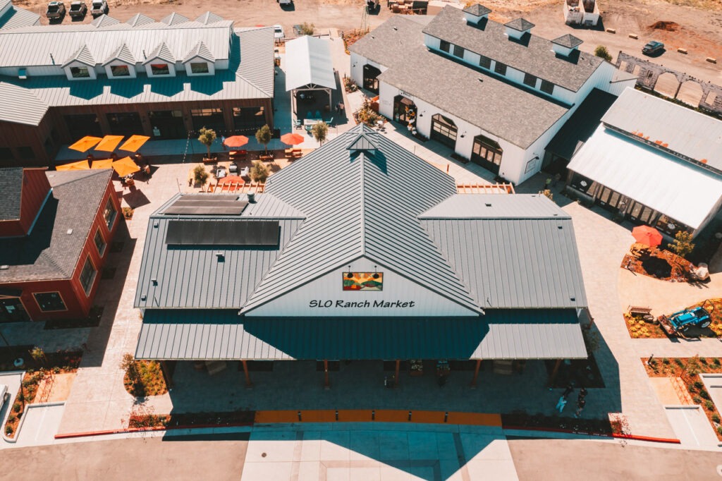 a commercial market building with a grey roof